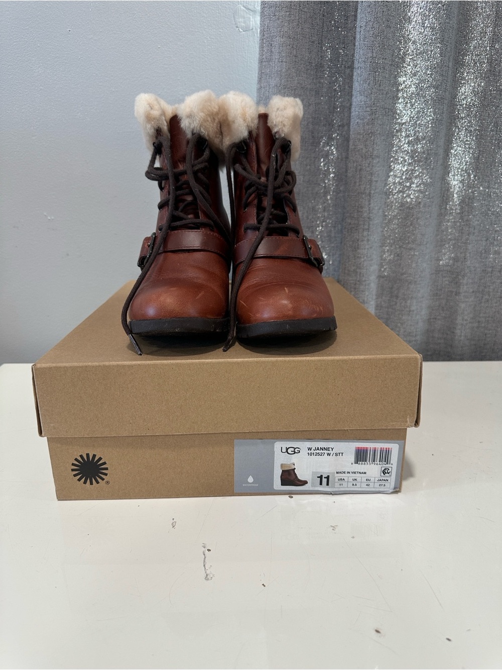 UGG women’s Brown Leather Lace-Up Boots with Cream Fur cuff. Size 11